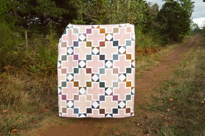 The Tabitha Quilt Pattern by Kitchen Table Quilting using Nocturne from Fableism. This is a fat eighth, fat quarter, or layer cake friendly patterns that is great for experienced beginners.