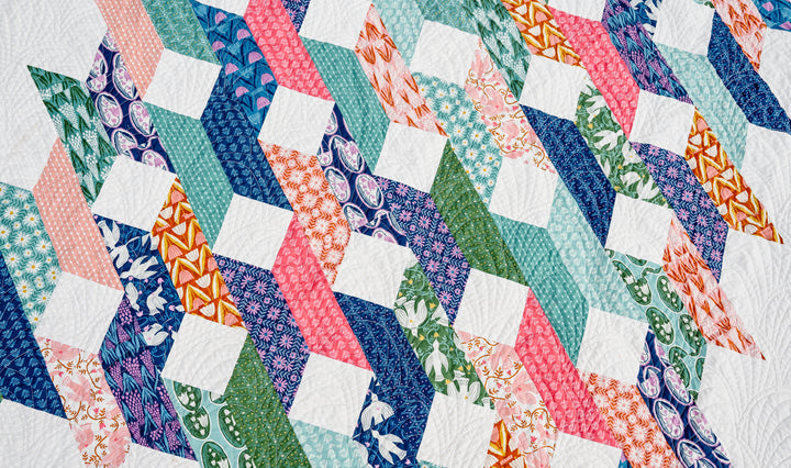 A finished Molly Quilt showcasing bold colors and large-scale prints, designed with visual movement and modern style.